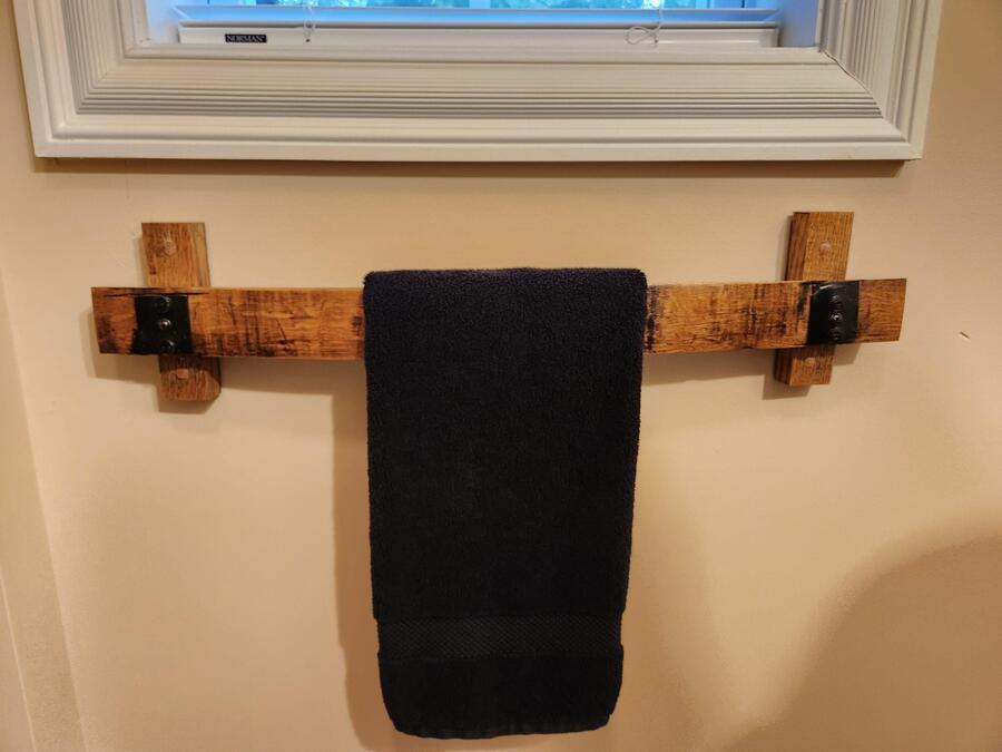 Barrel stave towel rack mounted to a wall