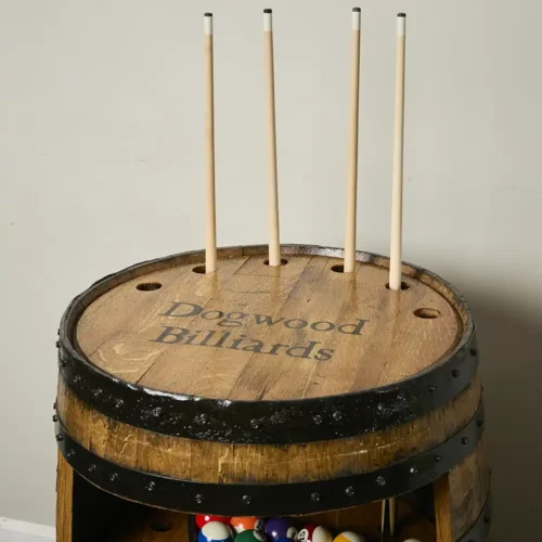 Top of whiskey barrel billiards cabinet holding 4 cue sticks