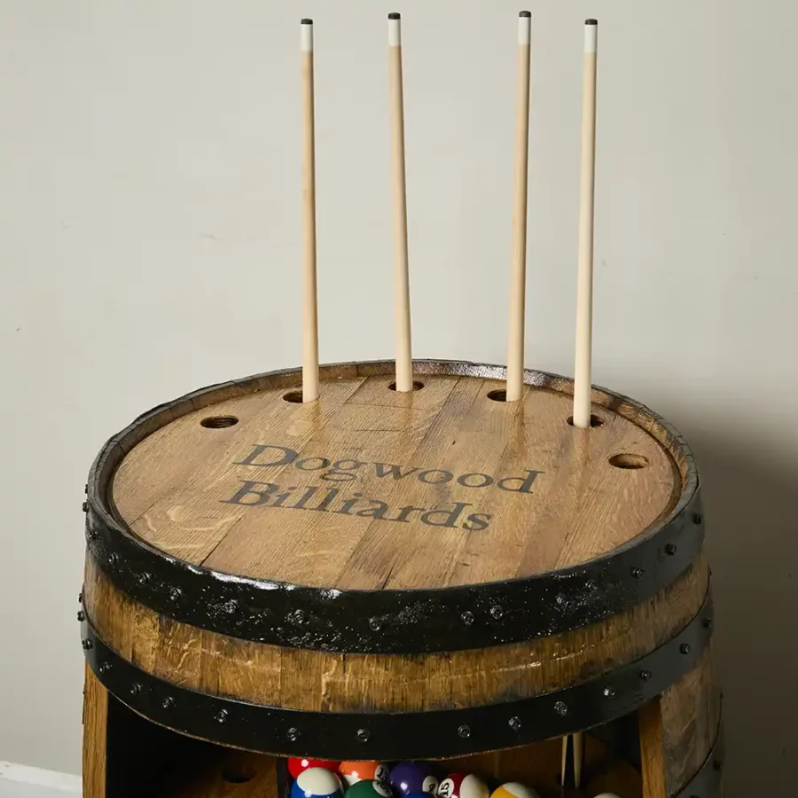 Top of whiskey barrel billiards cabinet holding 4 cue sticks