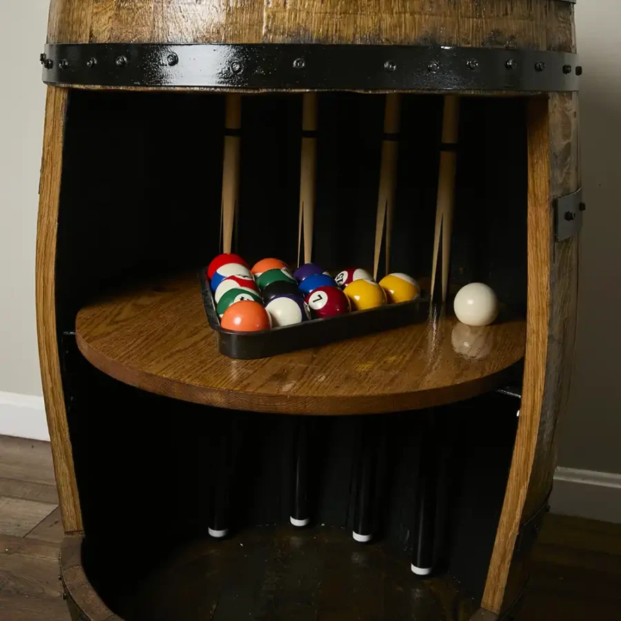 Billiard cabinet made from bourbon barrel with pool balls on shelf
