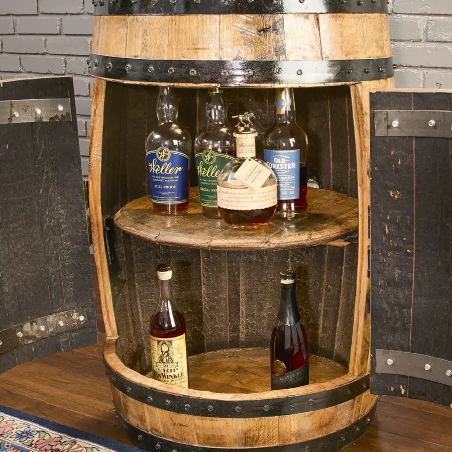 Whiskey barrel cabinet with doors, lights, and a barrel lid shelf. Liquor bottles inside. Metal rings painted black