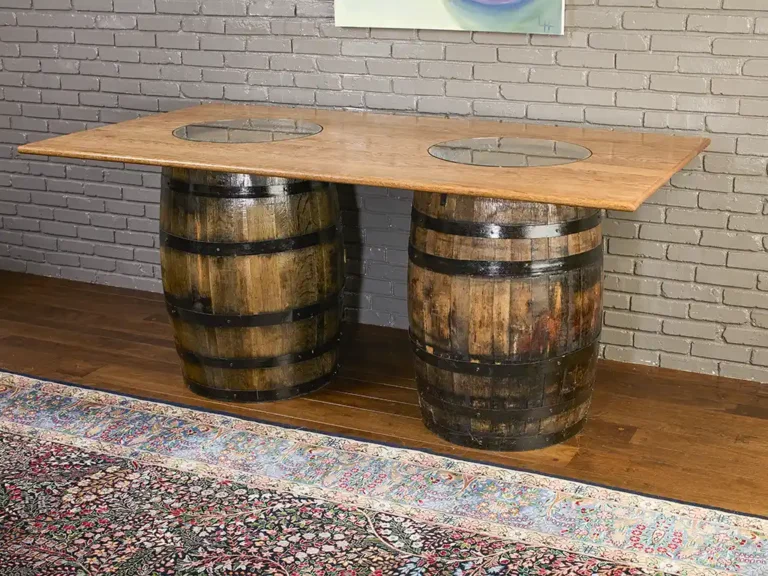 2 whiskey barrel table with a solid oak top and 2 glass inserts to show the distillery stamps on the barrels.