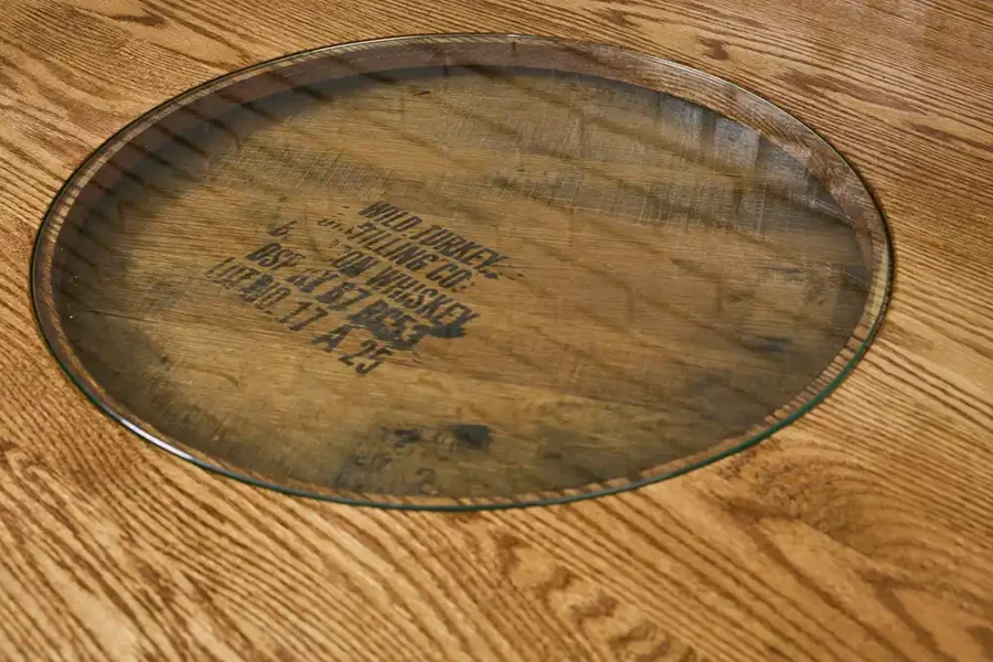 solid oak tabletop on a barrel table with the glass insert to show off the distillery stamp on the barrel