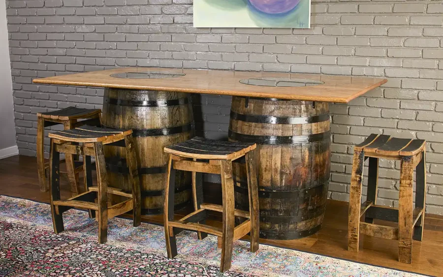 2 Bourbon whiskey barrels used as a base for a solid oak table top. Barrel stave stools without a backrest around the table