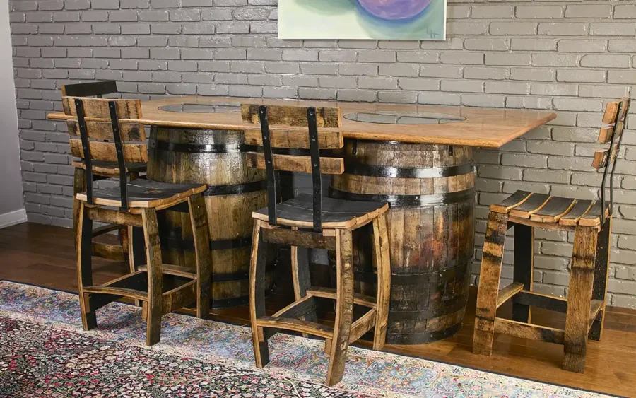 2 whiskey barrels used as a base for a solid oak table top. 2 glass inserts in the table to see the distillery stamp on the barrels. 4 stave chairs with backrest