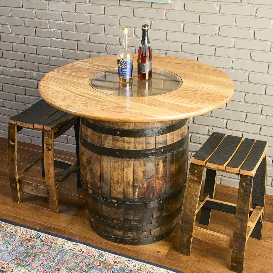 A whiskey barrel table with a solid oak top and glass insert with 2 barrel stave stools.