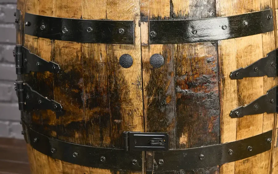 Whiskey barrel cabinet with tall doors with safety hasp closed so doors can be locked.