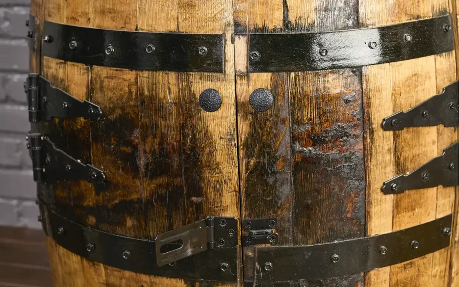 Whiskey barrel cabinet with tall doors with safety hasp open. Metal rings painted black to match hardware.
