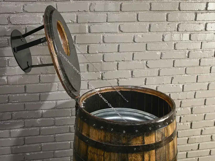 Deluxe barrel trash can cover with lid open and supported by chains. Metal liner inside the barrel