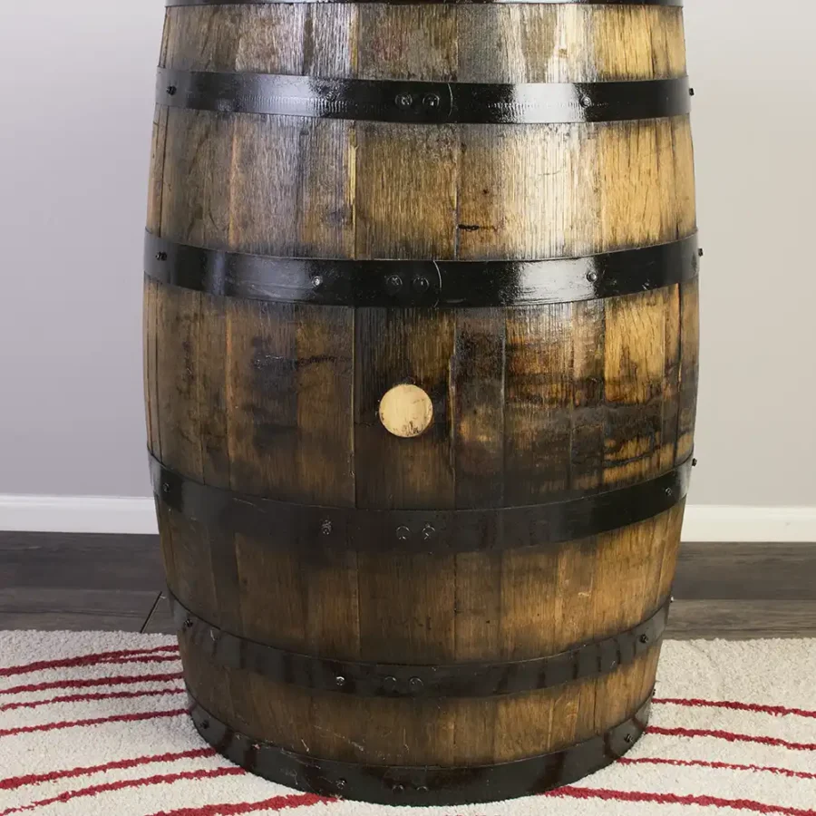Side of refurbished whiskey barrel showing the bung plug on the barrel