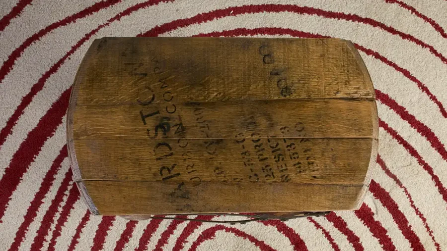 Top view of whiskey barrel end table with a rectangular shaped top with a distillery stamp on the lid