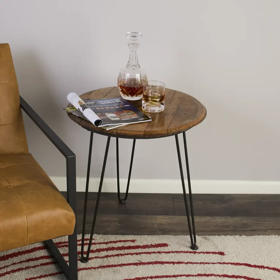 Whisky bottle and glass on the barrel head end table with hairpin legs