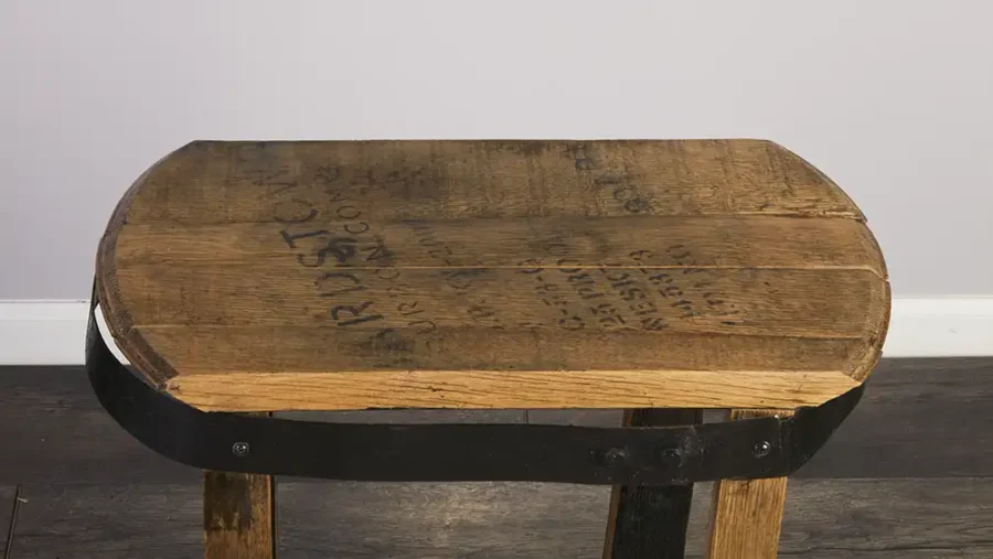 Top of whiskey barrel end table with the rectangle top. Metal ring painted black to accent the end table.