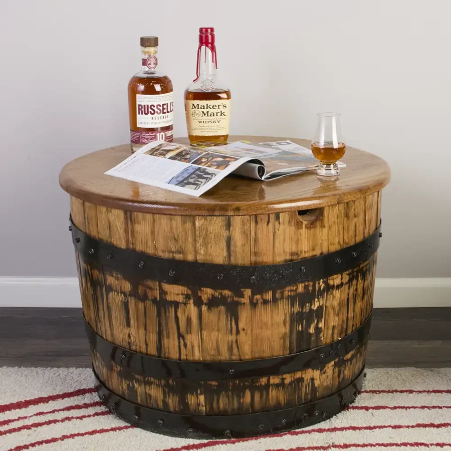 Half barrel coffee table with black metal rings and whiskey on the oak top