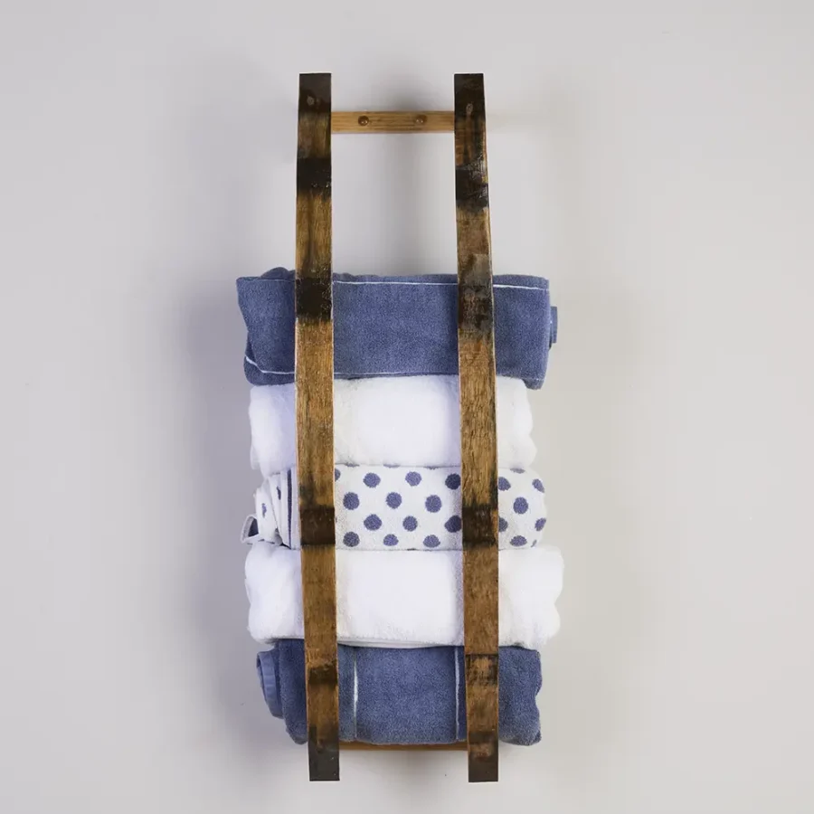 Barrel stave towel rack holding multiple rolled bath towels